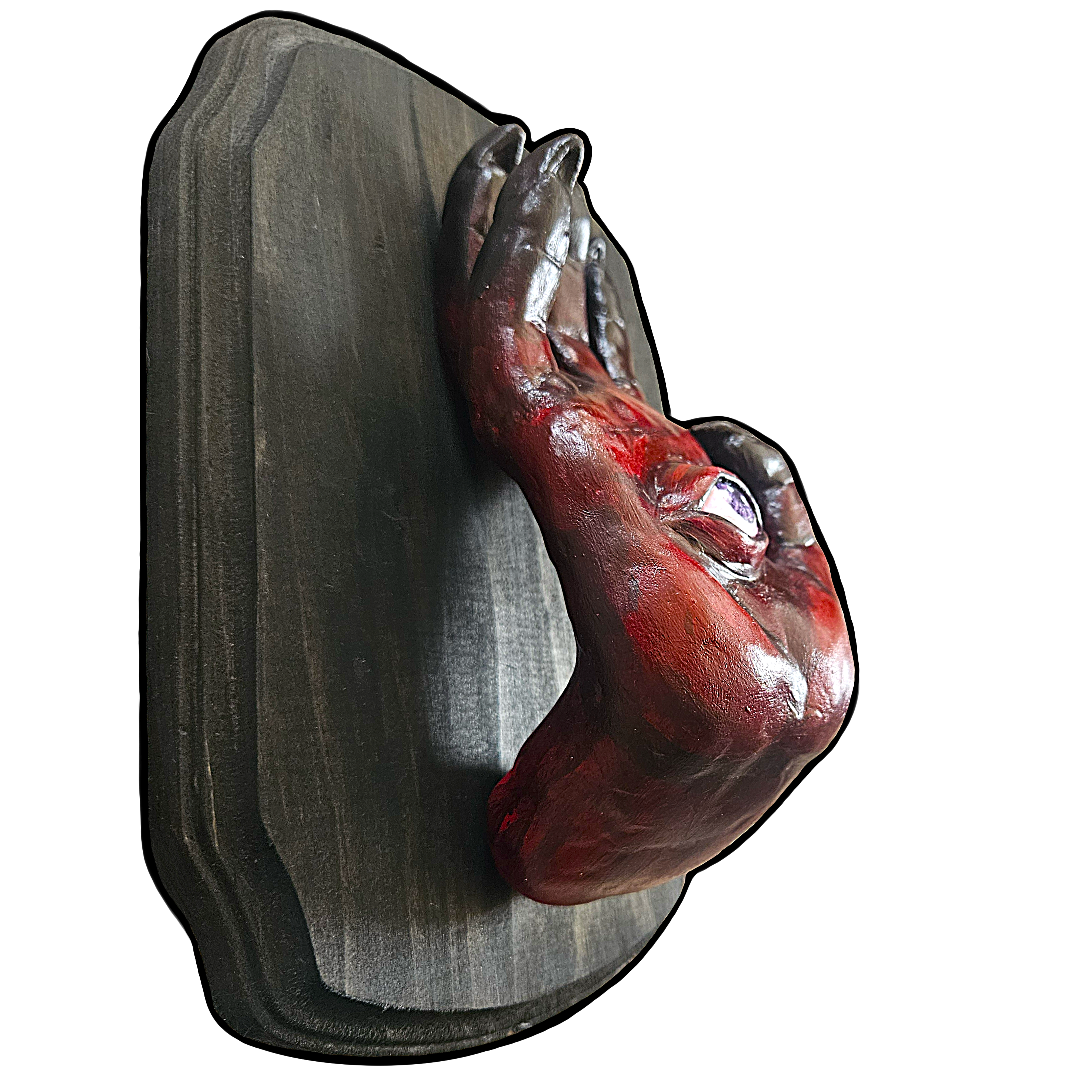  dark red demon hand sculpture with a purple eye on the palm
